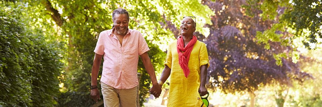 A senior couple walking outside.